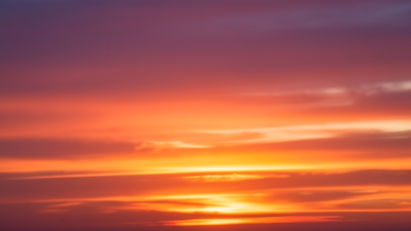 Sunset sky gradient background with soft clouds and warm colors